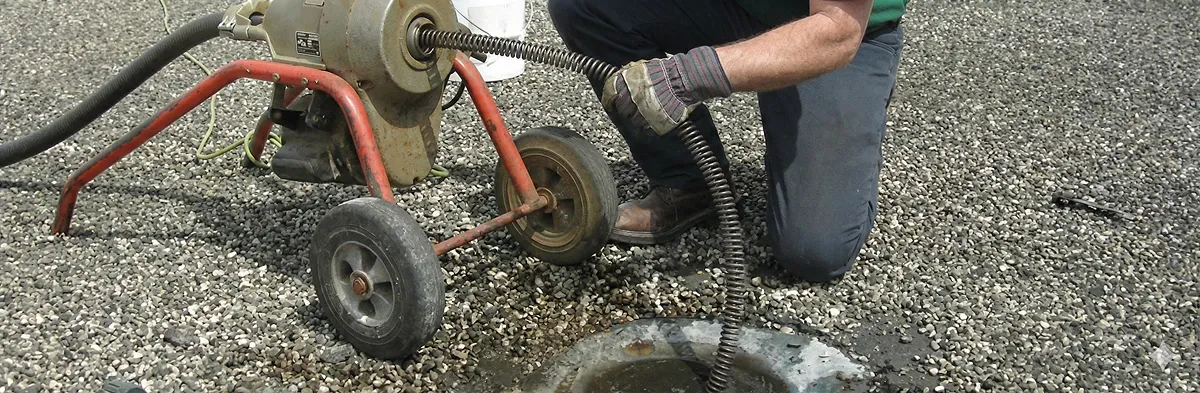 sewer rodding technician actively removing blockages from a sewer line in Houston, TX